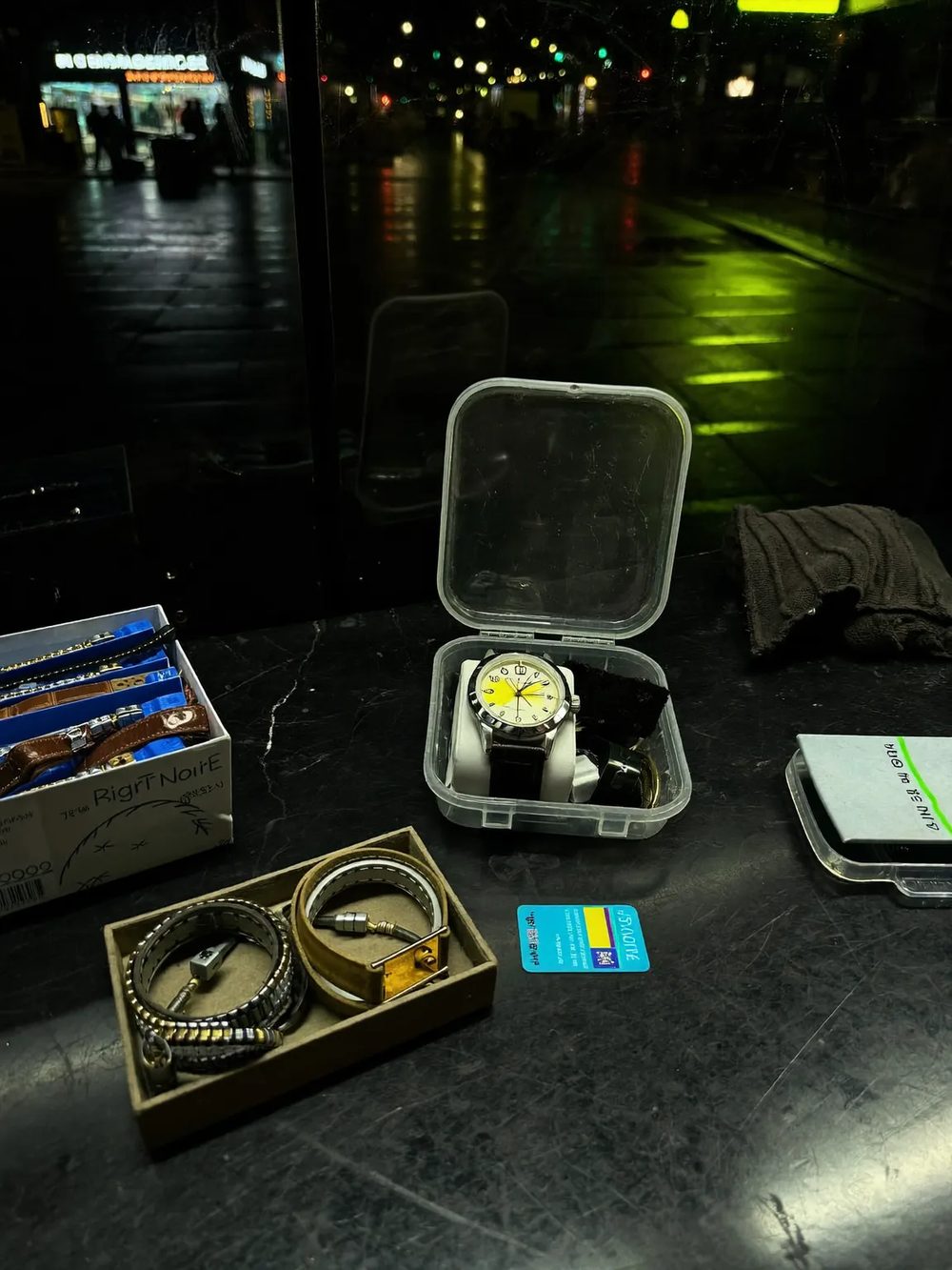Spare straps, bracelet links and small parts left out on the repair counter